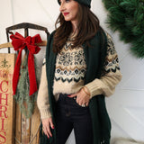 Woman styled in oatmeal Kenaby Fair Isle sweater paired with jeans for a warm, casual winter look.