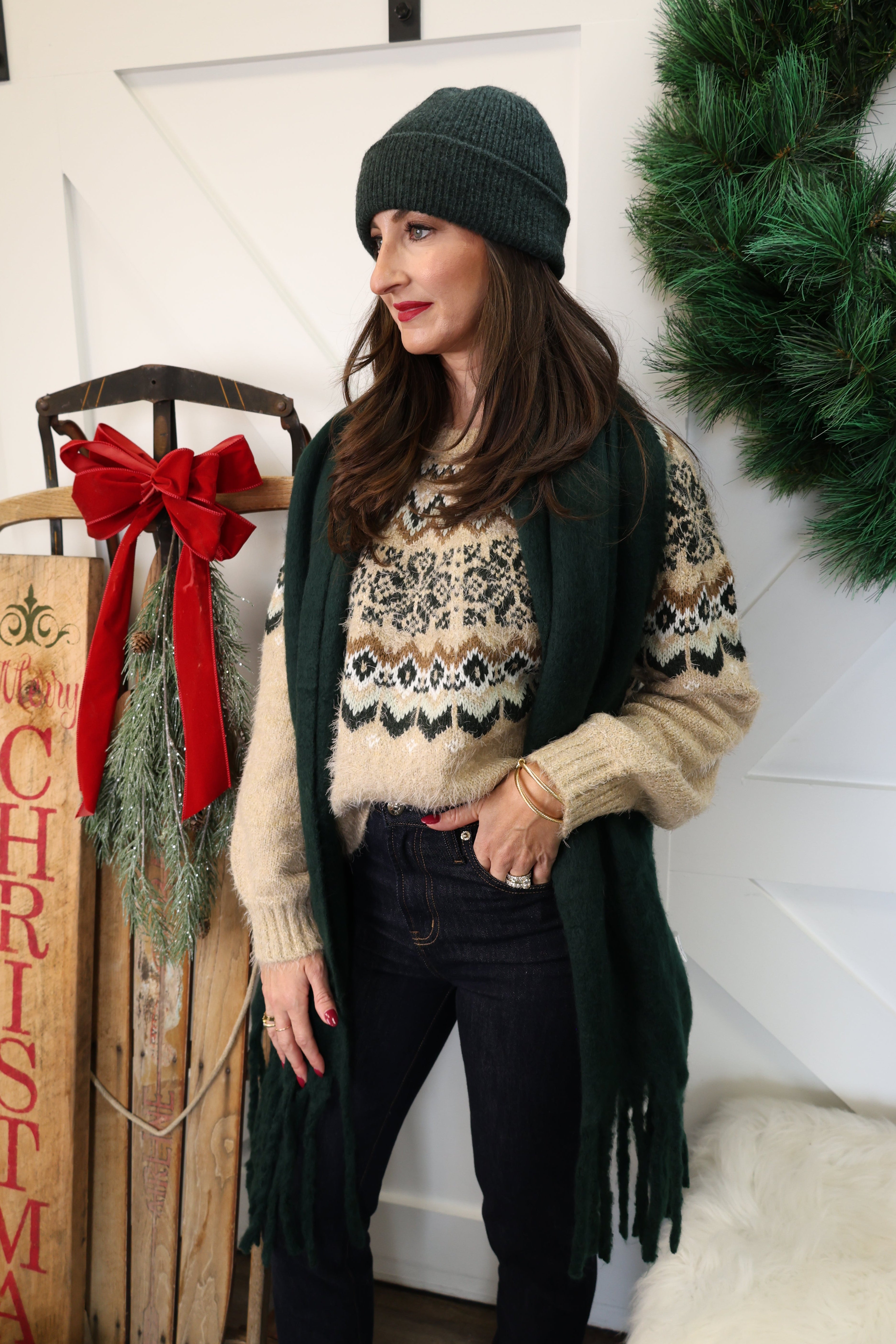 Woman styled in oatmeal Kenaby Fair Isle sweater paired with jeans for a warm, casual winter look.