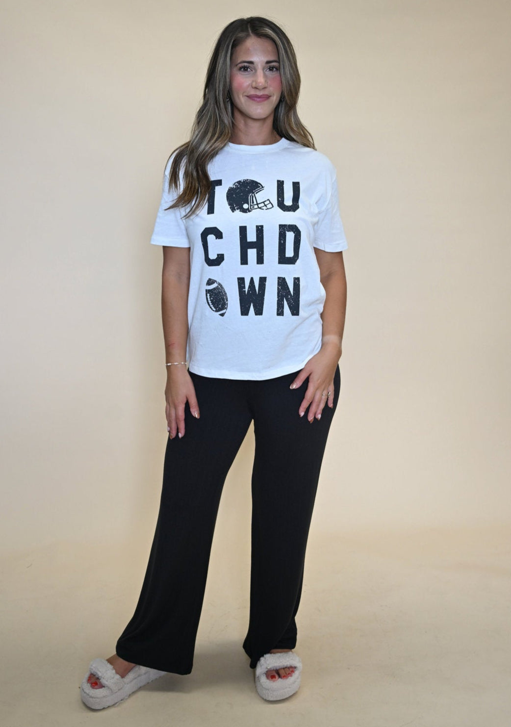 Comfy oversized white T-shirt by Z Supply with black “Touchdown” text across the front, styled in a casual boyfriend cut.
