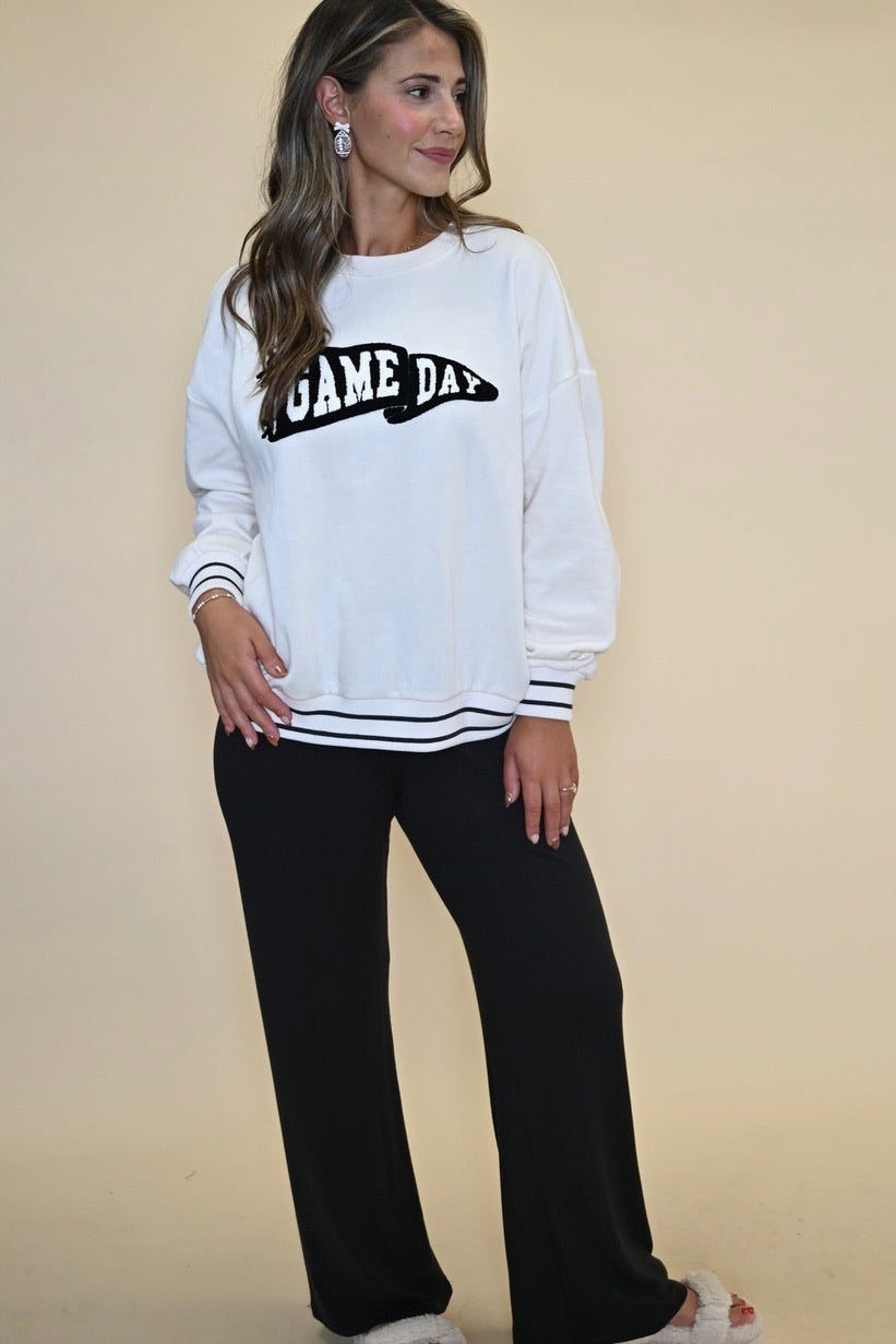 Women’s Z Supply Game Day Sweatshirt featuring a relaxed oversized fit, white body with black striped sleeves, and a heavy soft wash finish.