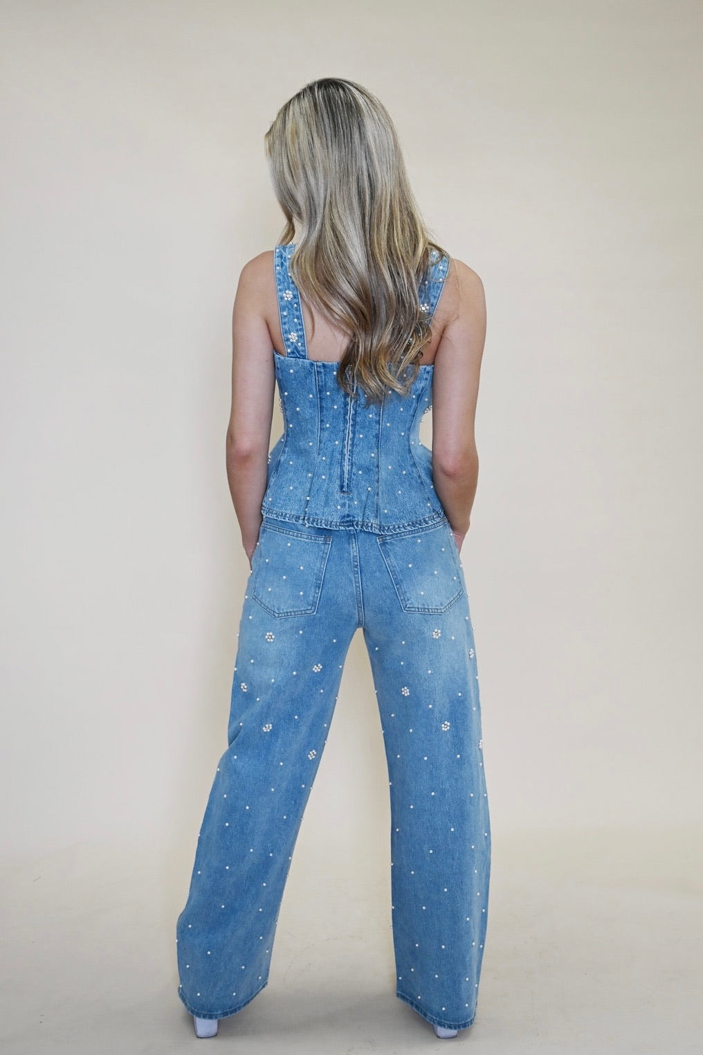 Back view of model in Steve Madden Fiorella Embellished Denim Top and Fianna Embellished Barrel Jeans, showing fit and detailing