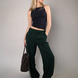 Comfortable Z Supply Saunder track pant made from light, flowy fabric with a wide leg, full-length fit, elastic waistband, and slash pockets.