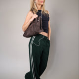 Z Supply Saunder track pant featuring a lightweight, flowy fabric with a wide leg silhouette, full-length fit, elastic waistband, and slash pockets.