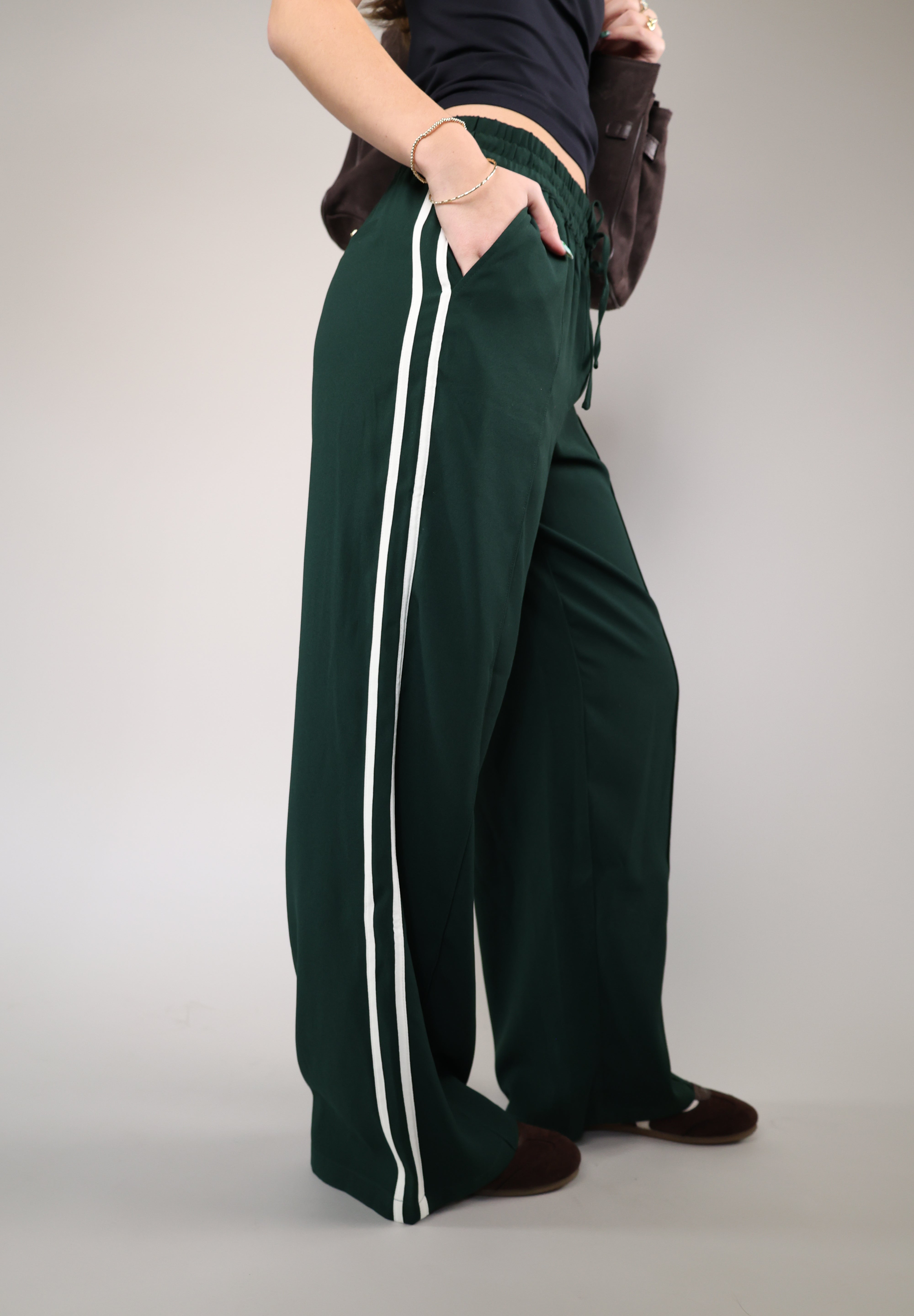Z Supply Saunder flowy track pant with a wide leg design, full-length styling, elastic waistband, and functional slash pockets.