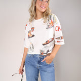 Free People Mountain View Graphic Tee featuring outdoor-inspired illustrations with mountains, boots, canoe, and van design.