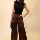 Silky brown DeLuc pants featuring a flattering high waist and wide-leg design.