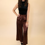 High-waisted, wide leg Brown pants with a luxurious silky finish from DeLuc. 