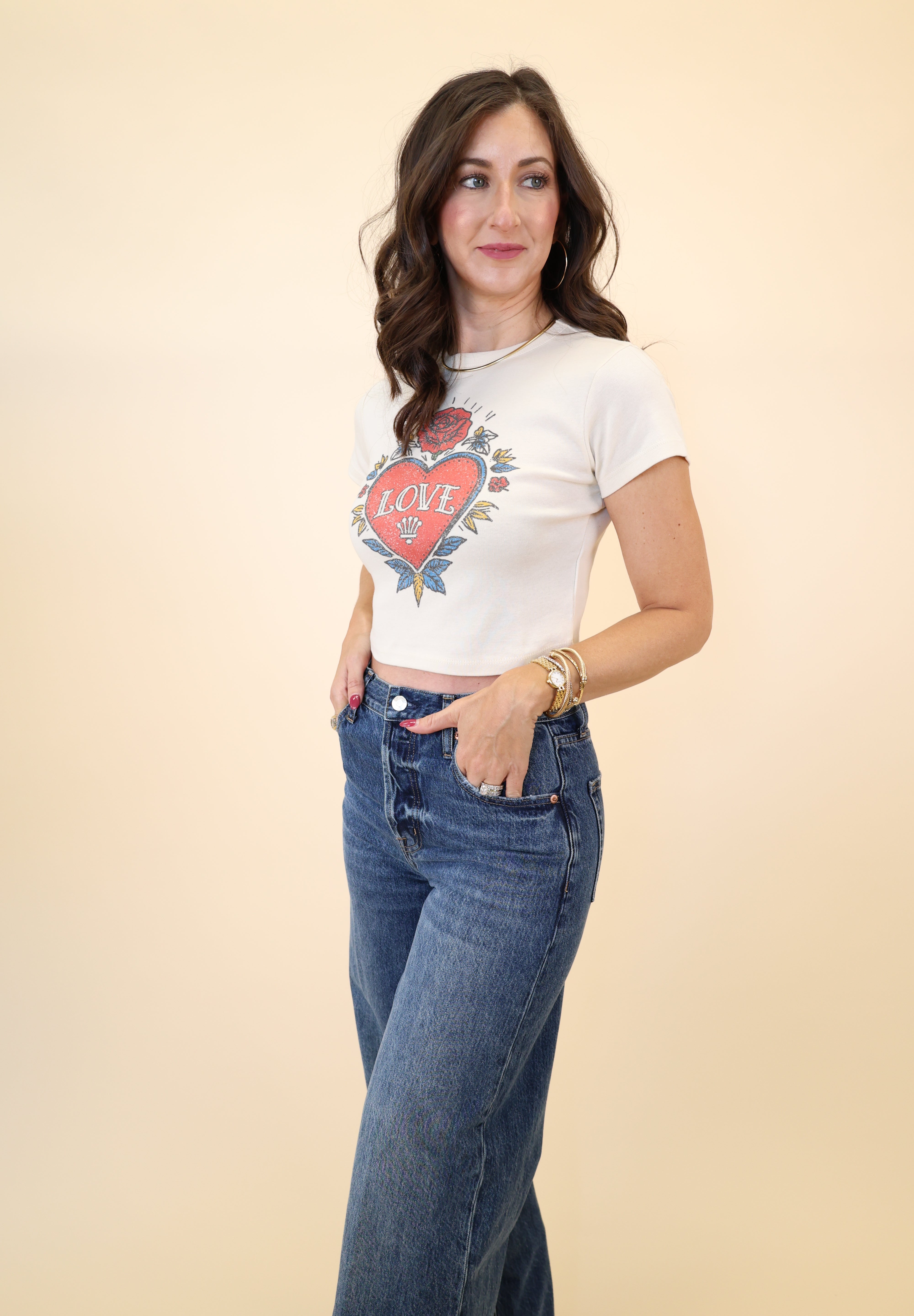 Girl Dangerous white baby tee with red heart tattoo “Love” graphic and soft cotton fit