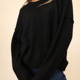 Dear John Ayat Sweater in black featuring a crewneck, drop shoulders, and ribbed sleeves.