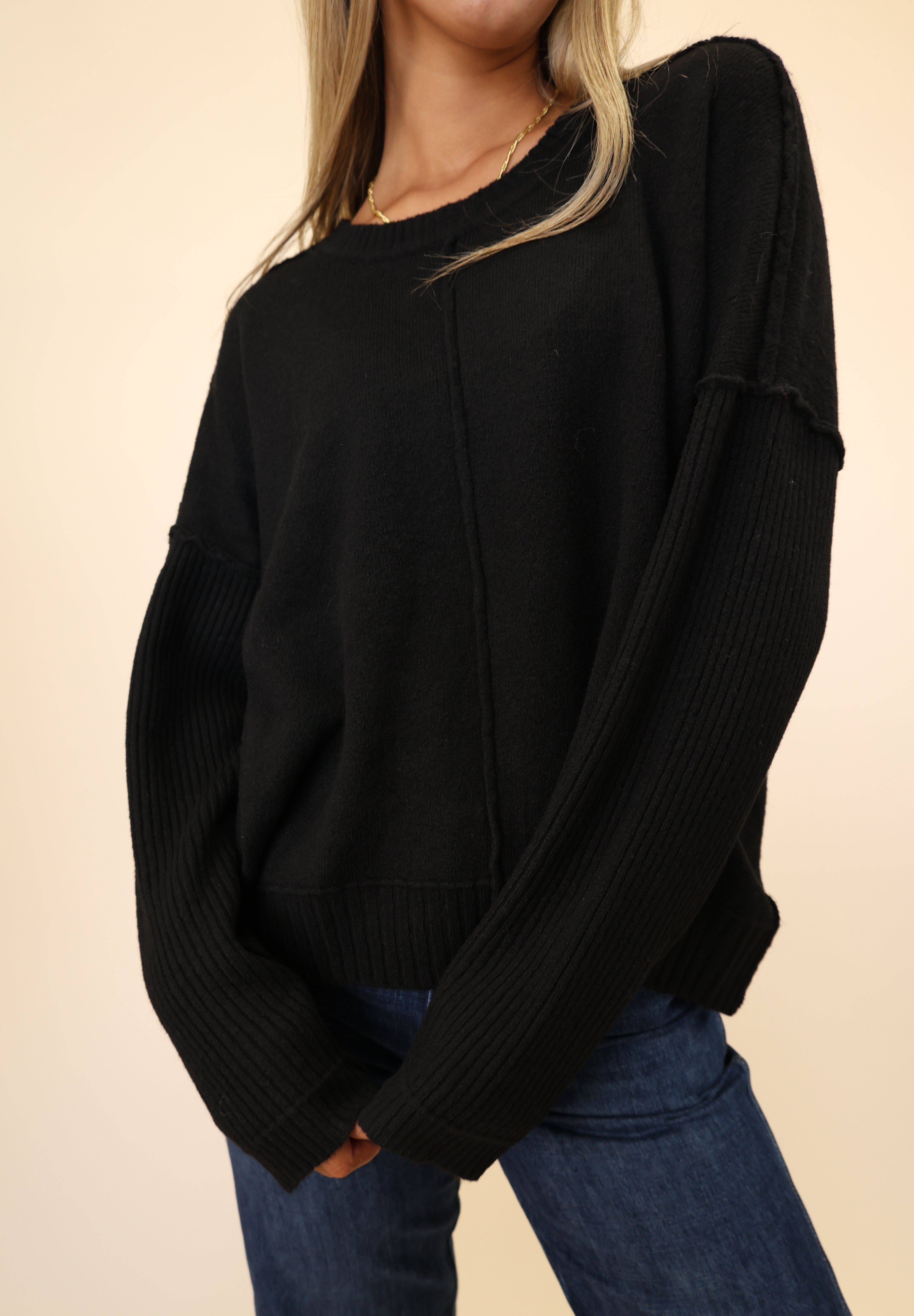 Dear John Ayat Sweater in black featuring a crewneck, drop shoulders, and ribbed sleeves.