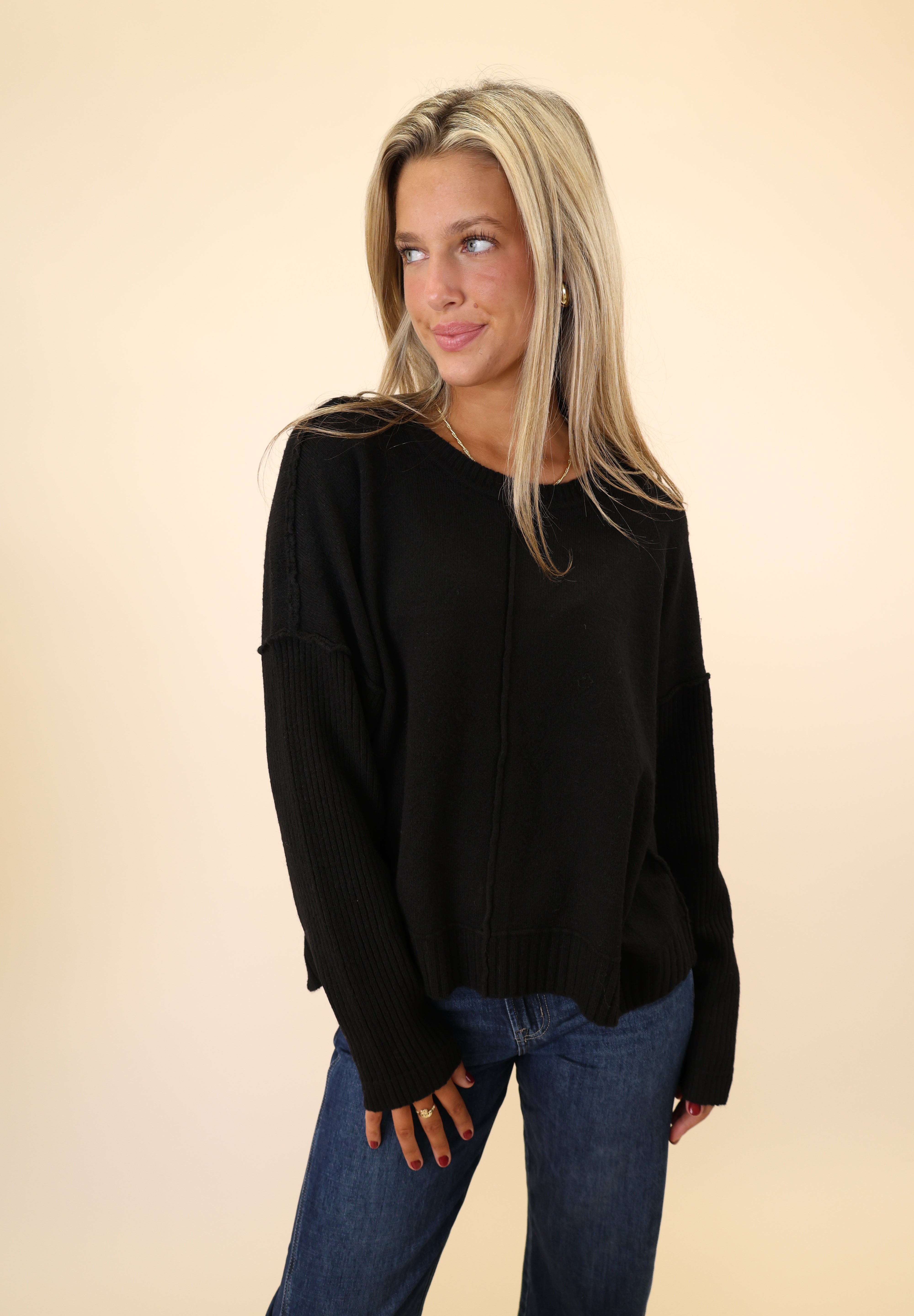 Dear John black Ayat Sweater with a classic crew neckline, ribbed sleeves, and a casual drop-shoulder fit.