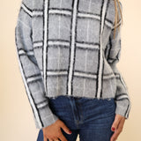 Stylish women’s DeLuc Jacob grey plaid long-sleeve mock-neck sweater.
