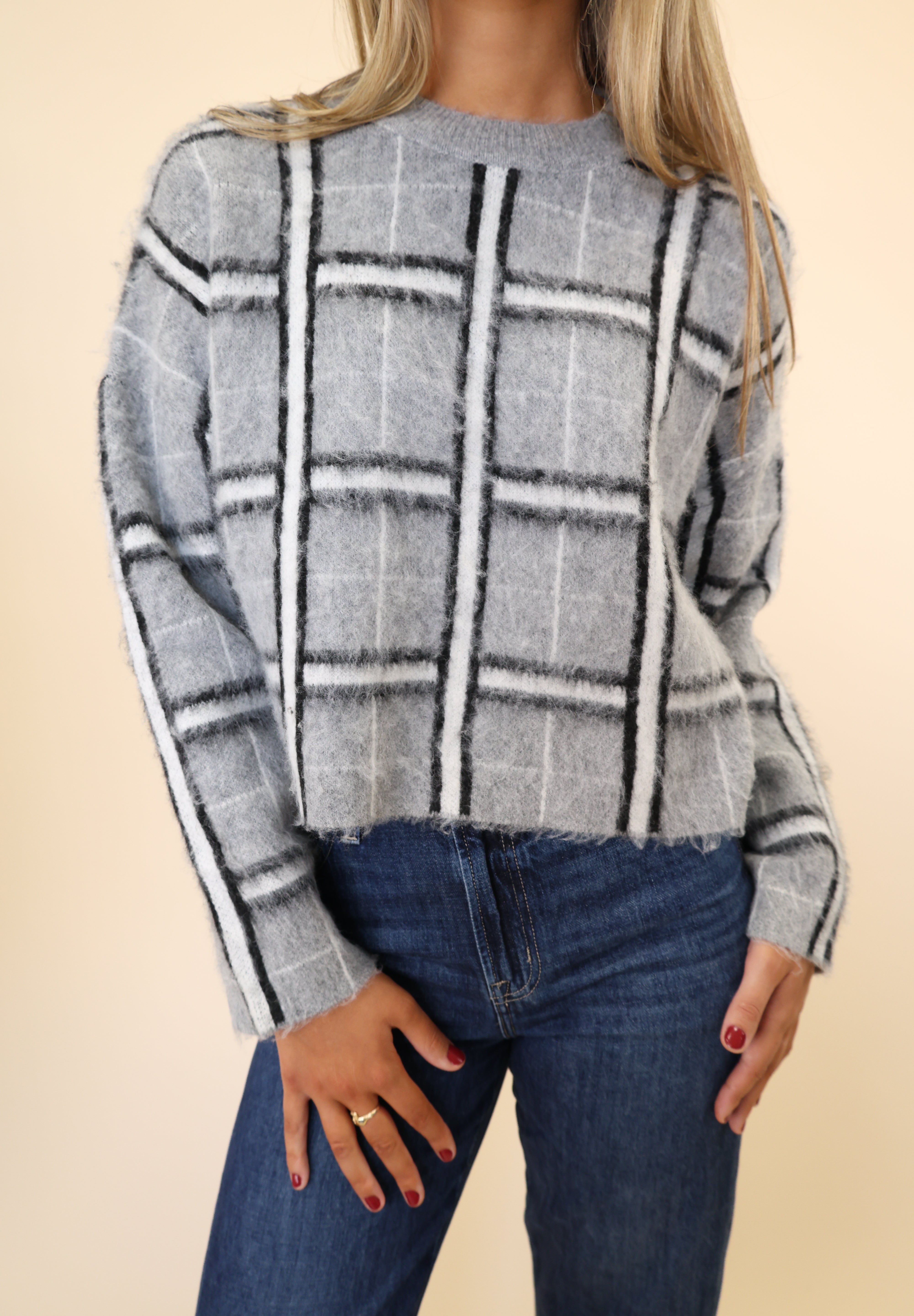 Stylish women’s DeLuc Jacob grey plaid long-sleeve mock-neck sweater.