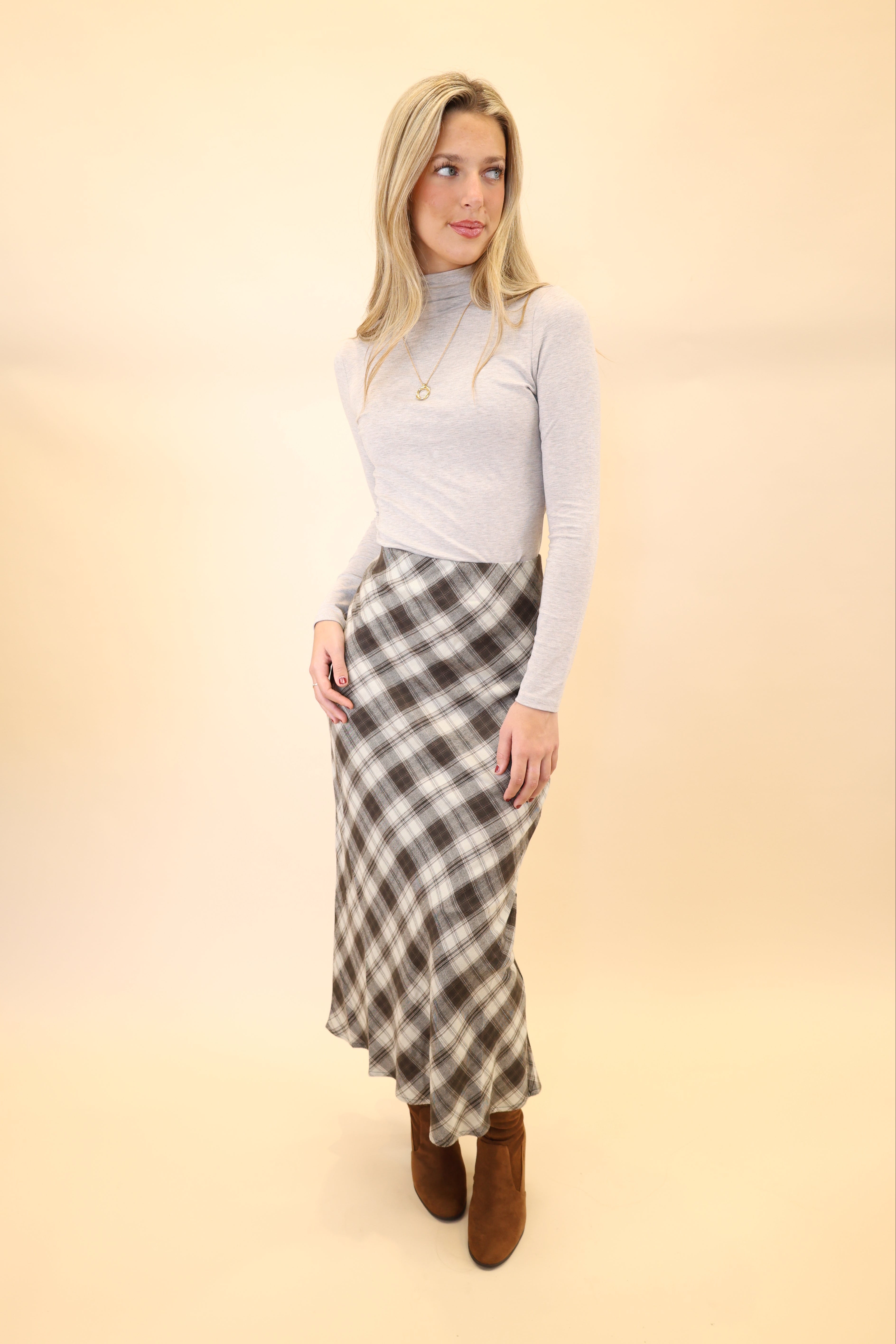 Z Supply Europa plaid midi skirt displayed on hanger, highlighting the timeless plaid pattern and midi length.