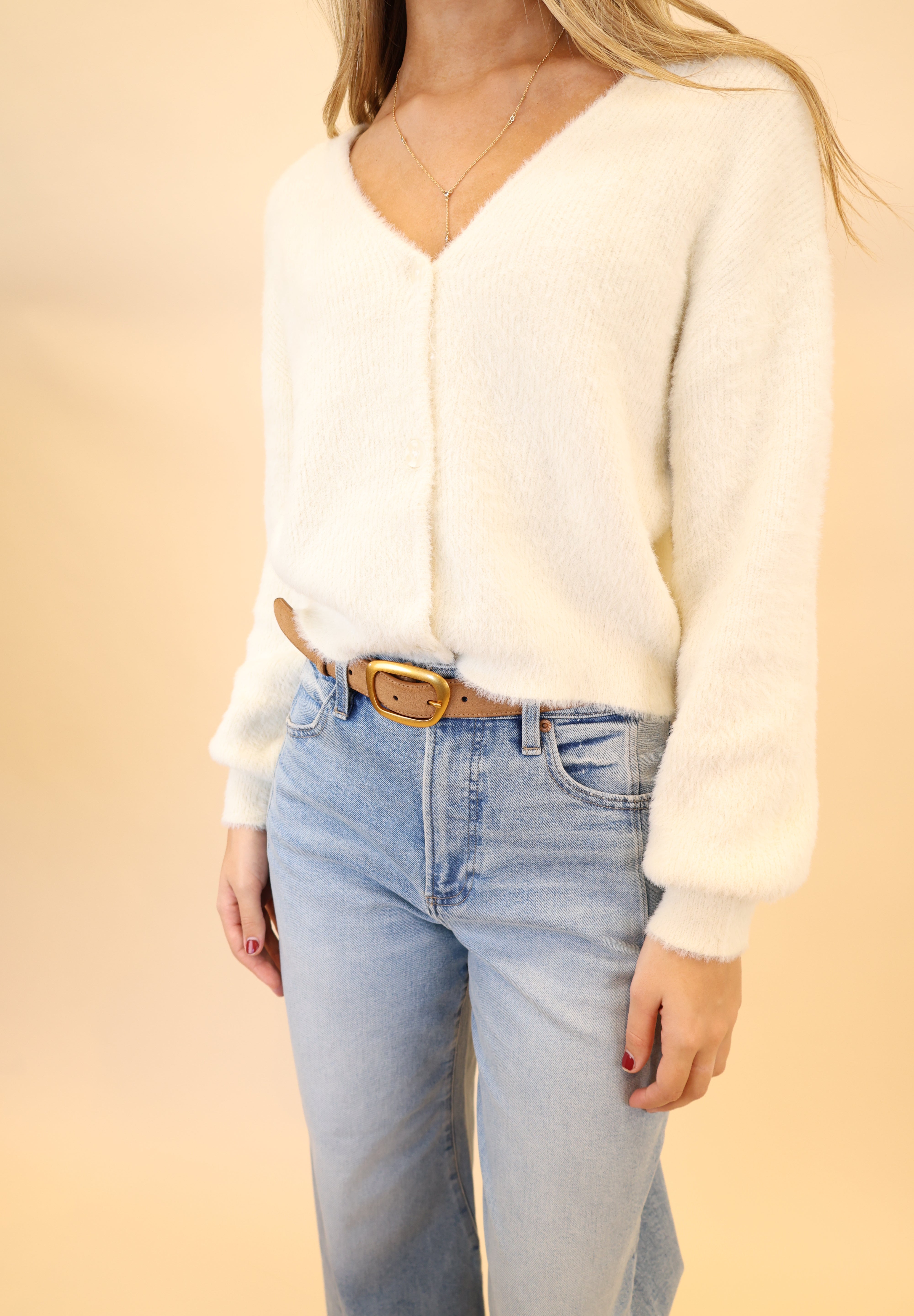 White fluffy Sadira cardigan by Z Supply, featuring a cozy V-neck and long sleeves.