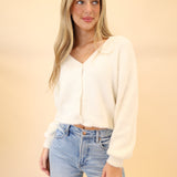 Model wearing white Z Supply Sadira fluffy cardigan with V-neckline, long sleeves, and button-front closure.