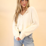 Woman styled in Z Supply Sadira white fluffy V-neck cardigan for a soft, casual look.