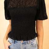 Close-up of Z Supply Glimpse top in black showing intricate floral lace detailing and scalloped ruffle trim.