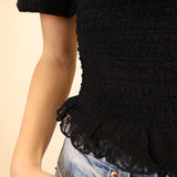 Z Supply Glimpse short-sleeve lace top in black with floral pattern and soft ruffle edging.