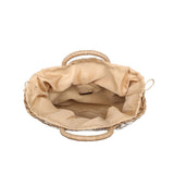Neutral woven summer tote with braided round handles and shell embellishments for coastal style