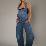 Woman wearing the Free People Good Luck Overall in Ultra Light Beam, featuring a relaxed oversized fit, wide-leg silhouette, and utility-inspired details.