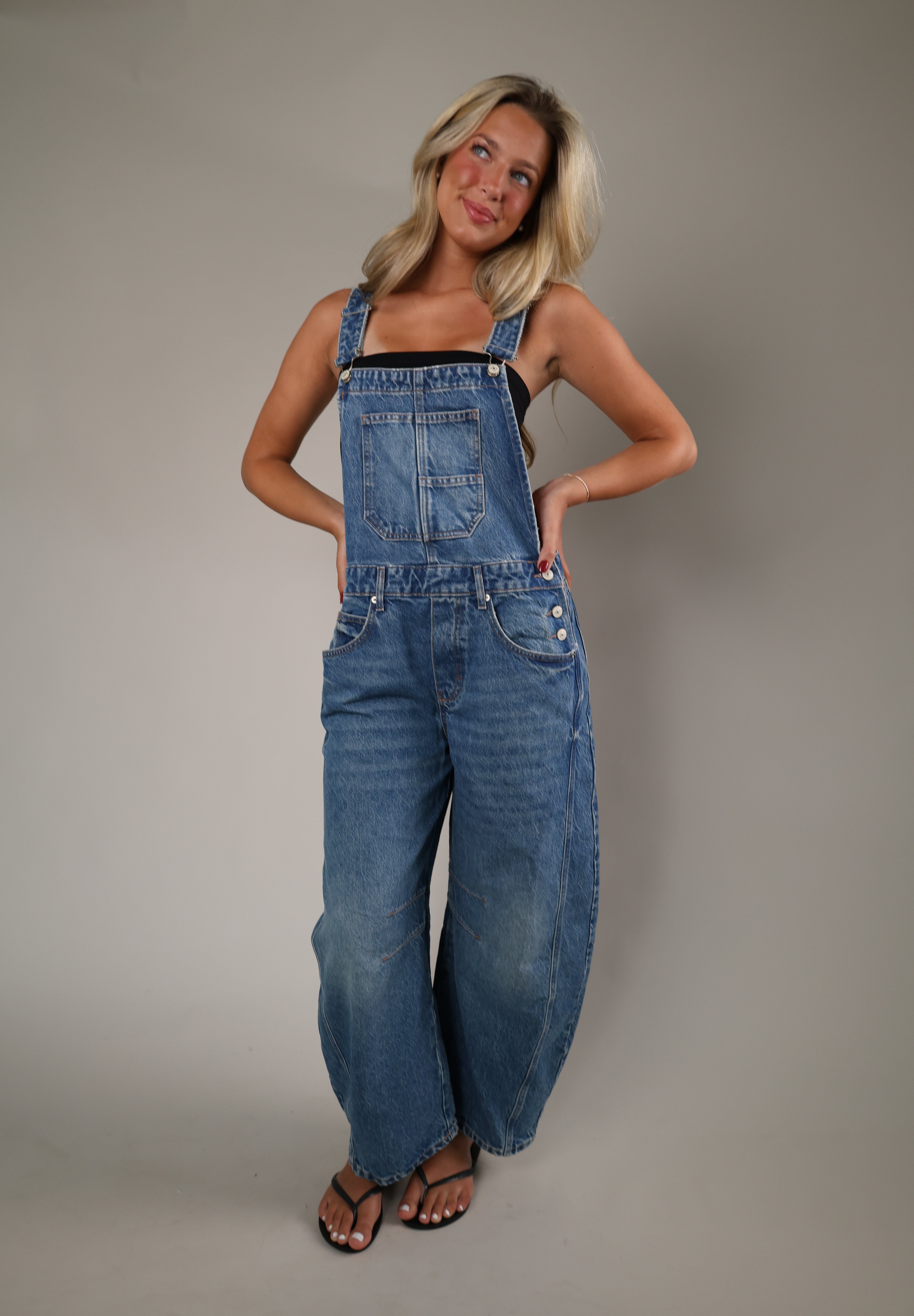 Light wash denim overalls with a relaxed wide-leg silhouette, oversized fit, and lived-in feel for easy everyday styling.