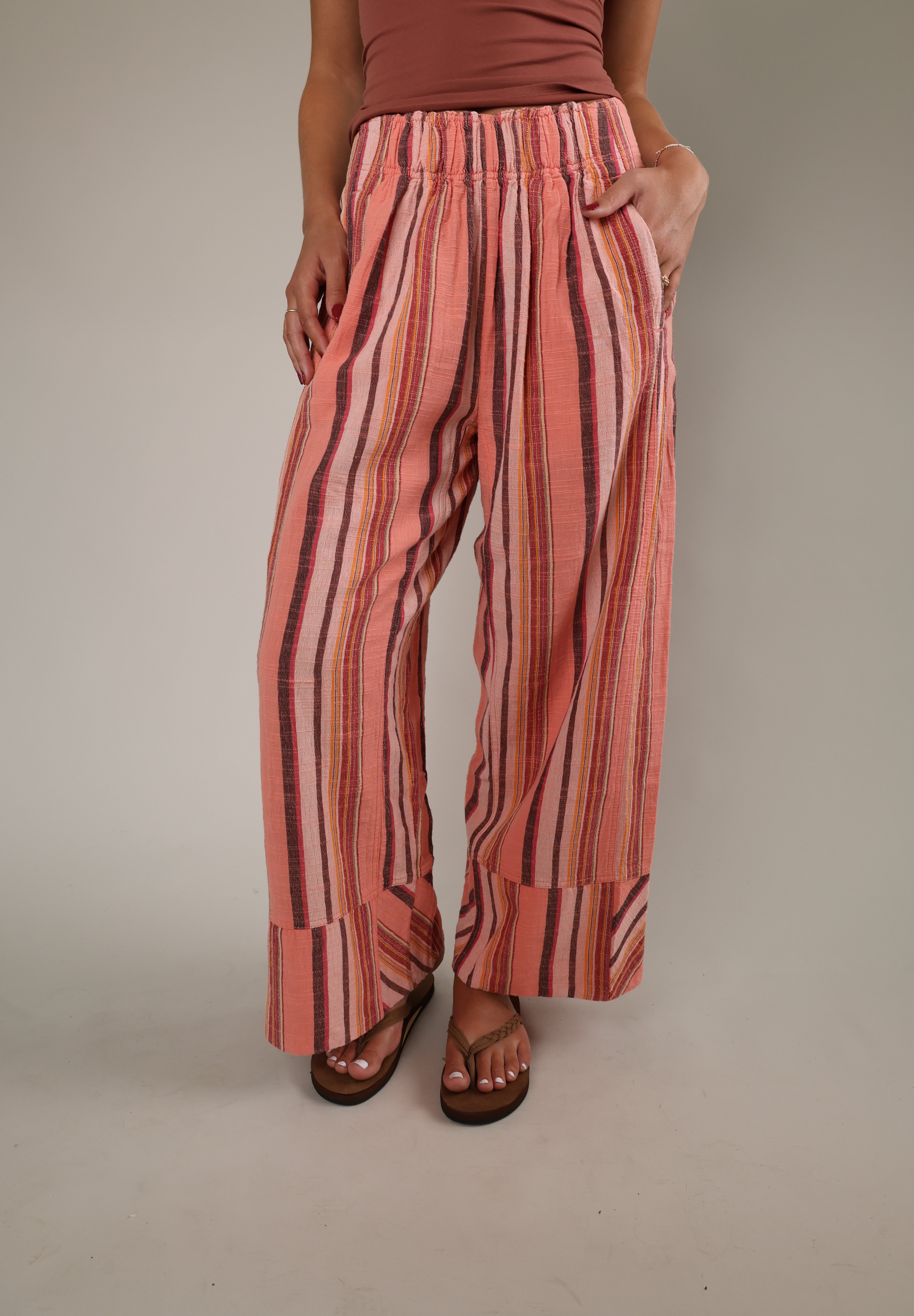 Free People Days End Linen Stripe Pant in Soft Coral Combo featuring relaxed wide-leg silhouette, lightweight linen blend fabric, stripe pattern, and elastic waistband