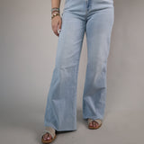 High-waisted light blue denim jeans featuring a wide-leg silhouette, subtle faded wash, and casual chic style.