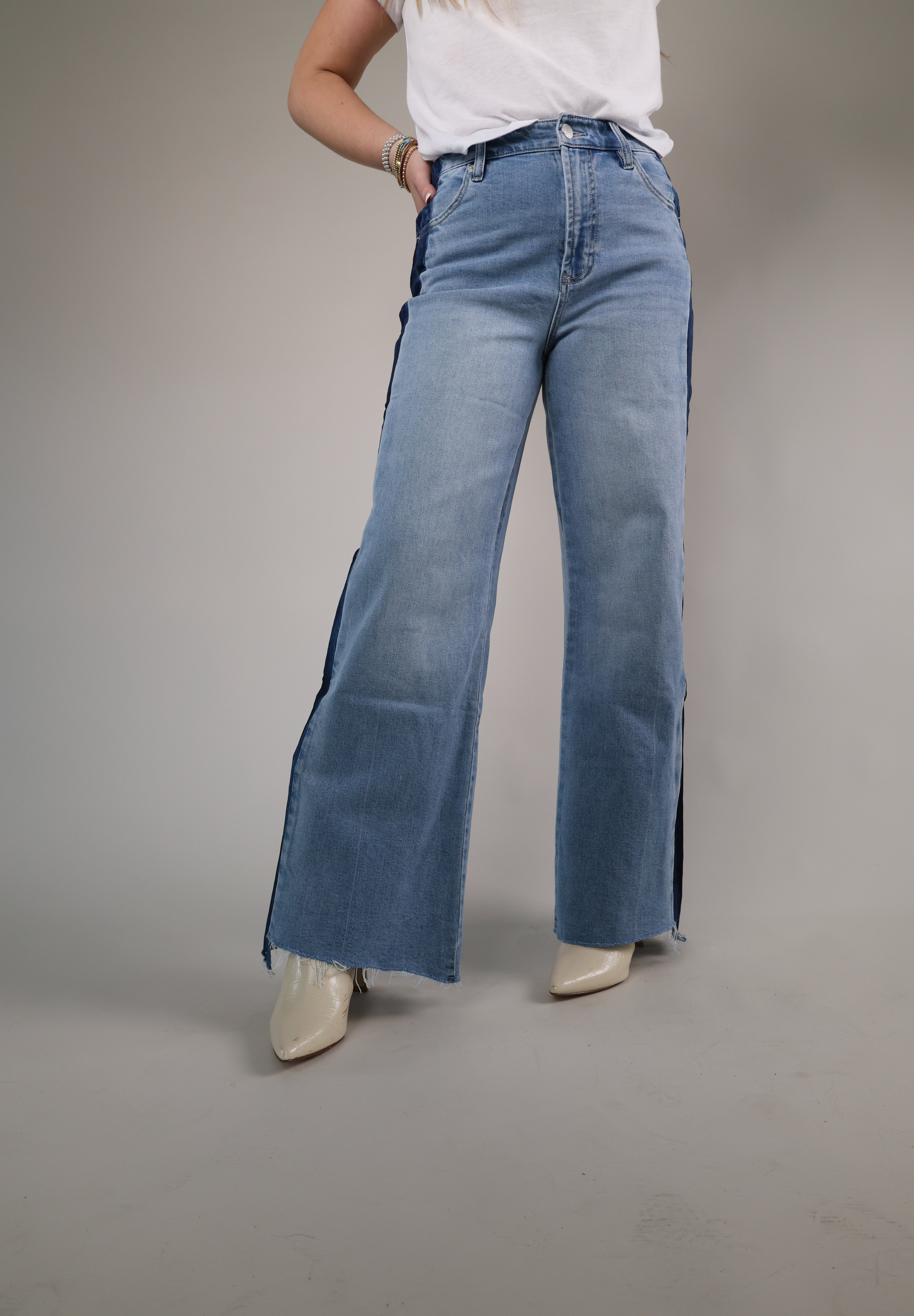 High-waisted wide-leg denim featuring mixed wash paneling, soft structured fabric, and an effortlessly cool statement look.