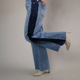 Two-tone wide-leg jeans by Dear John with light wash denim, dramatic flared legs, and bold dark wash stripe detailing down the sides.