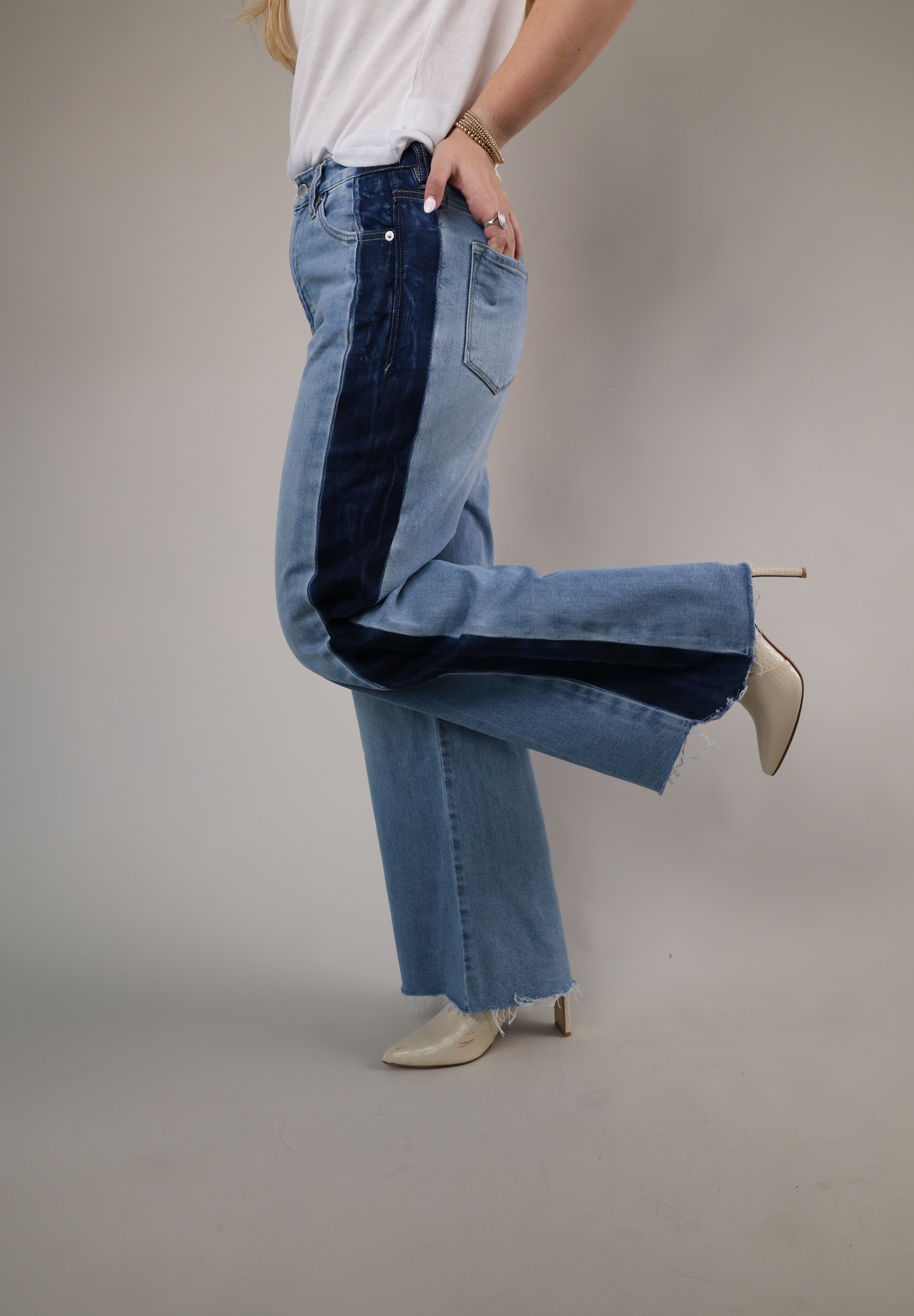 Two-tone wide-leg jeans by Dear John with light wash denim, dramatic flared legs, and bold dark wash stripe detailing down the sides.
