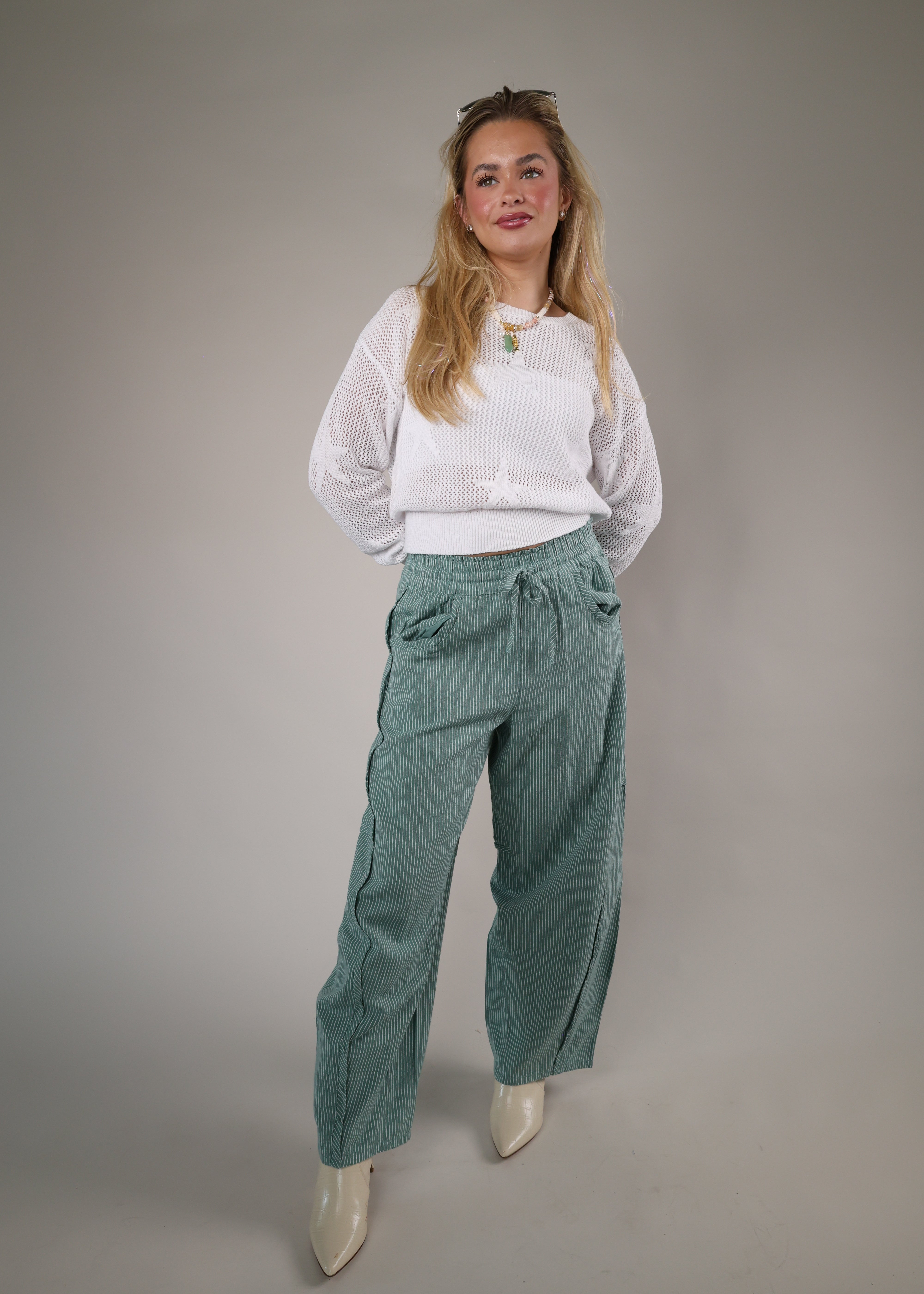 Cozy white knit sweater by Z Supply featuring a breathable crochet-style texture and ribbed waistband for an effortless look.