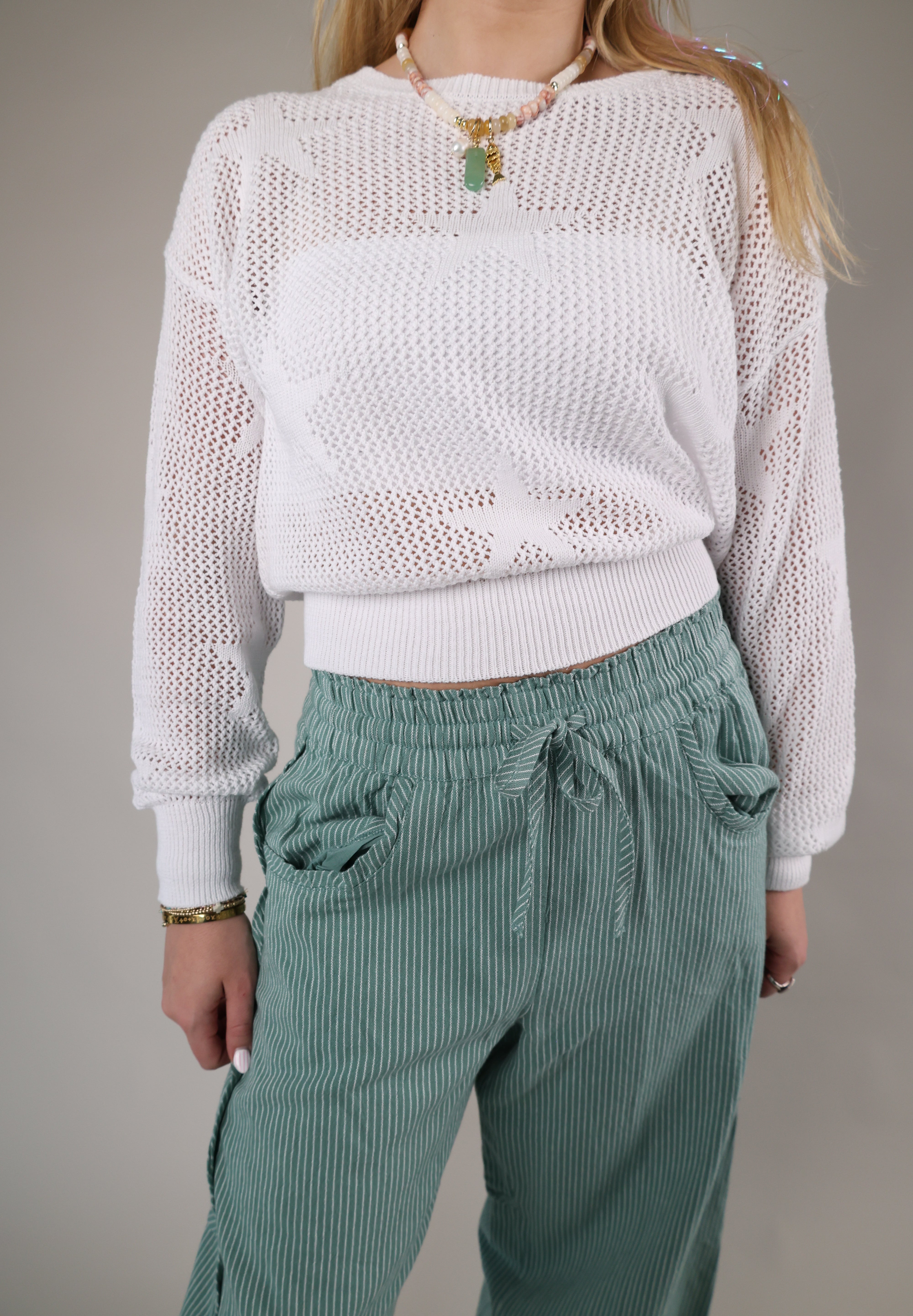 Woman wearing the Z Supply Star of the Show Sweater in a lightweight white open-knit design with long sleeves and a relaxed fit.