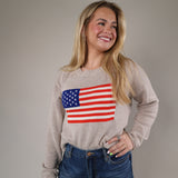 Cozy Z Supply Sienna Patriot Sweater featuring a relaxed fit, lightweight beige knit fabric, and bold USA flag design.