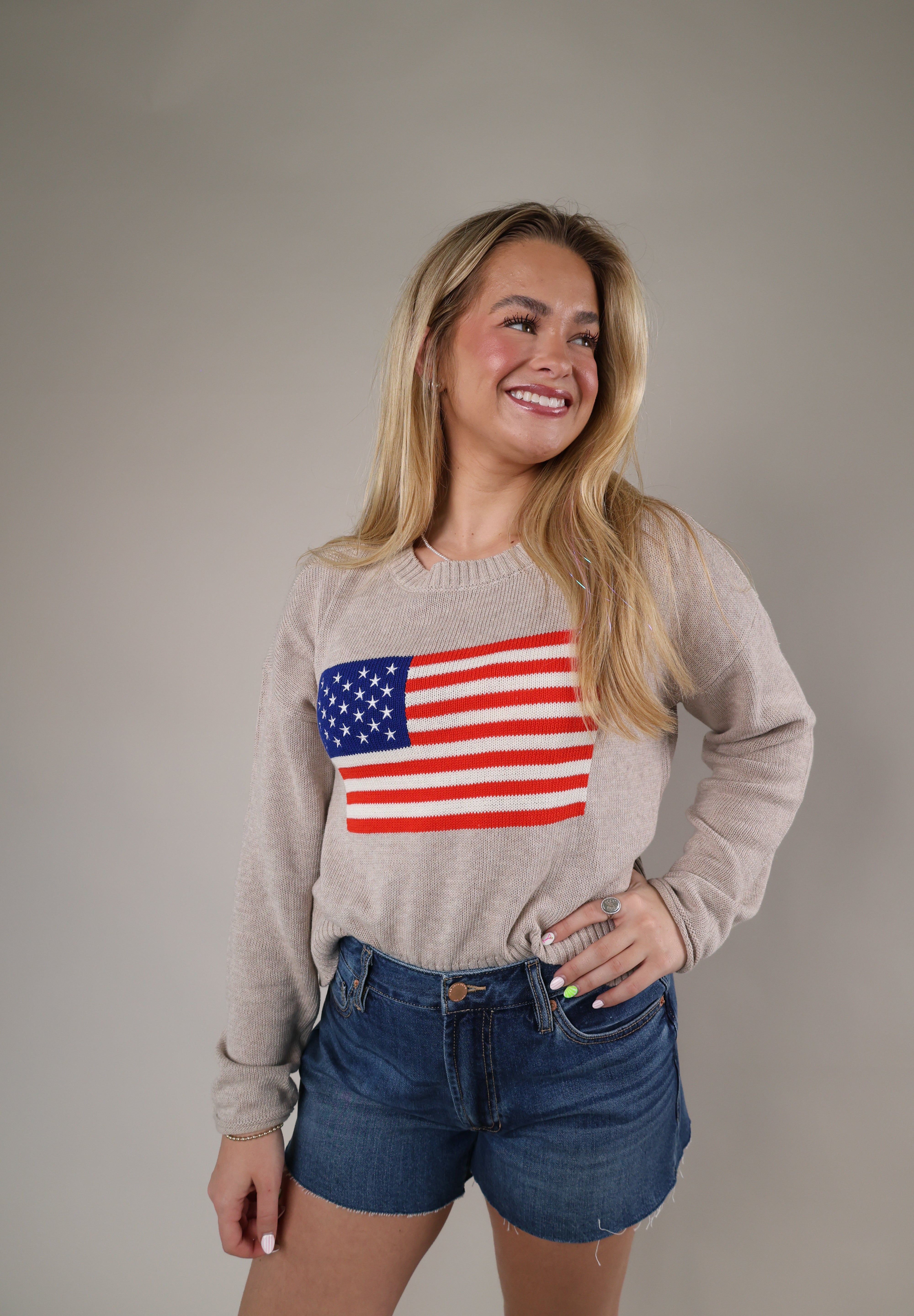 Cozy Z Supply Sienna Patriot Sweater featuring a relaxed fit, lightweight beige knit fabric, and bold USA flag design.