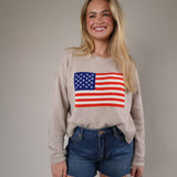Relaxed fit patriotic knit sweater with long sleeves and an American flag motif, perfect for casual summer nights and holiday weekends.