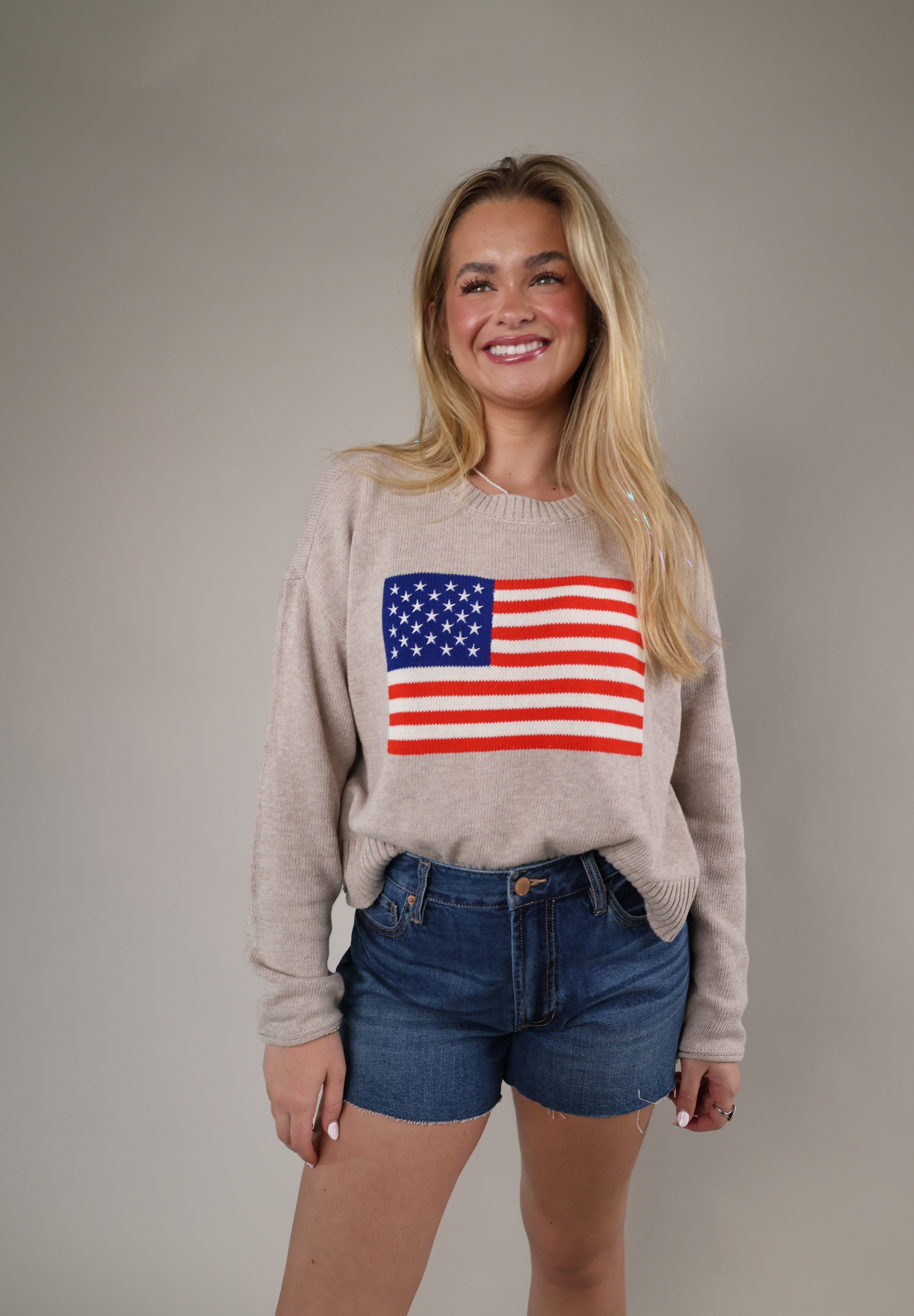 Relaxed fit patriotic knit sweater with long sleeves and an American flag motif, perfect for casual summer nights and holiday weekends.