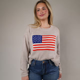 Neutral-toned Z Supply Sienna Patriot Sweater styled with denim shorts, featuring a vintage-inspired American flag graphic.