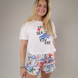 Soft white graphic t-shirt featuring nautical-inspired artwork, bold lettering, and an easy relaxed fit perfect for beach days.