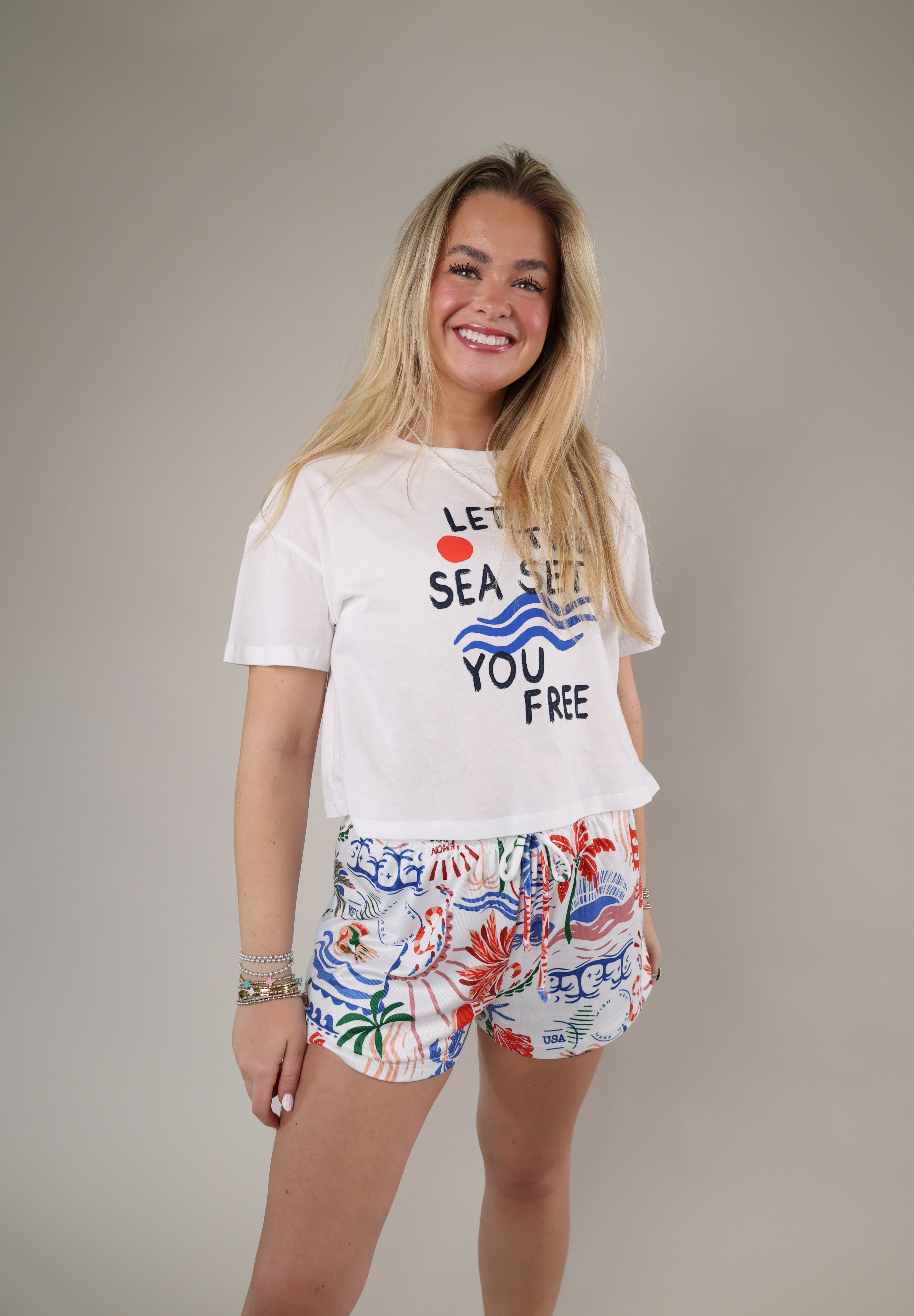 Soft white graphic t-shirt featuring nautical-inspired artwork, bold lettering, and an easy relaxed fit perfect for beach days.
