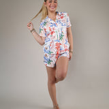 Woman wearing the Z Supply Classic Soley Getaway Shorts featuring a colorful tropical floral print and relaxed lightweight fit.