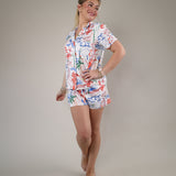 Casual floral print shorts by Z Supply styled with a matching button-up top for a coordinated vacation-ready look.