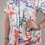 Lightweight tropical print shorts featuring bright coral, blue, and green accents with an easy relaxed silhouette.