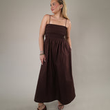 Woman wearing the Z Supply Cornelia Poplin Maxi Dress in Chocolate Cherry featuring a smocked bodice, spaghetti straps, and flowy maxi silhouette.