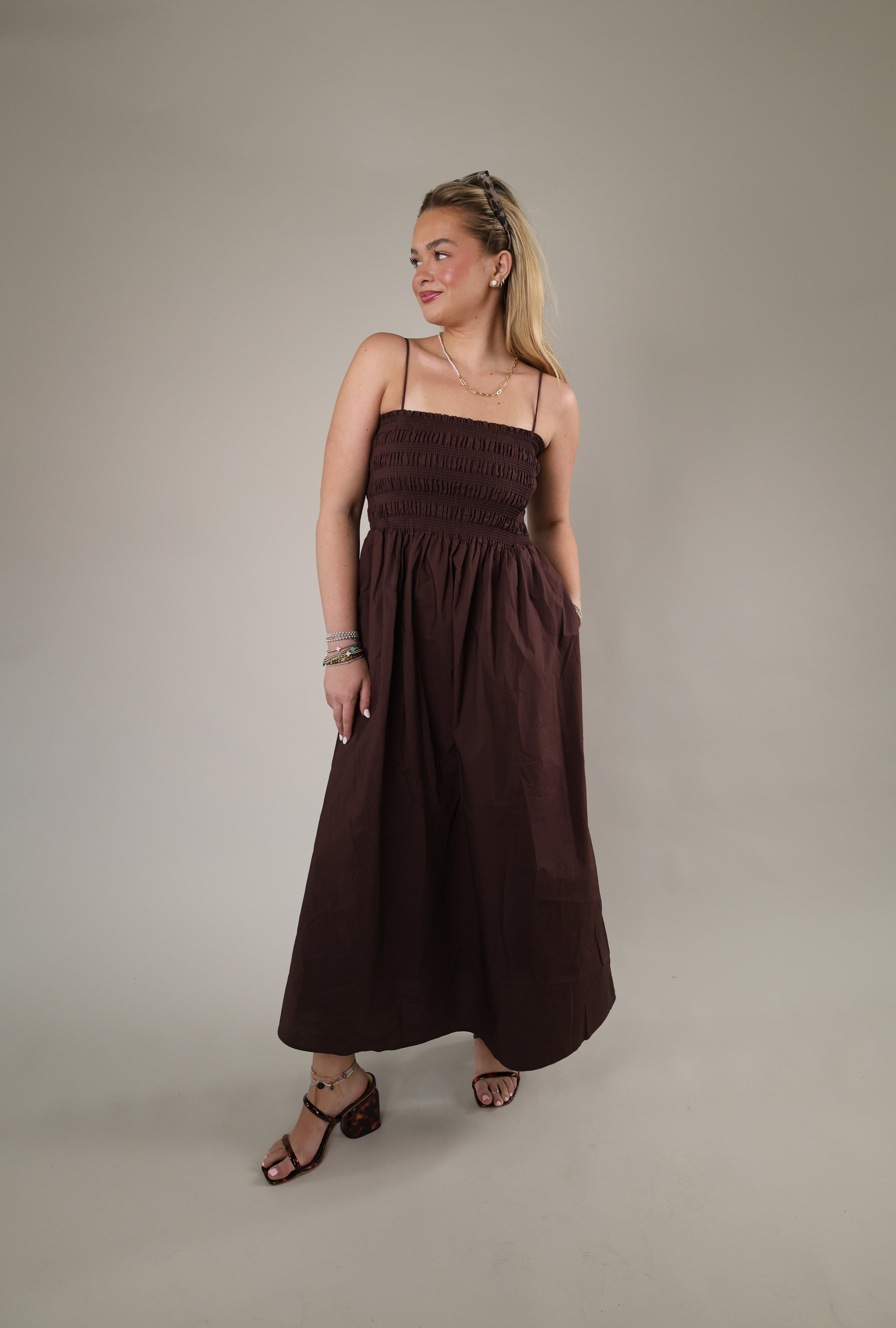 Woman wearing the Z Supply Cornelia Poplin Maxi Dress in Chocolate Cherry featuring a smocked bodice, spaghetti straps, and flowy maxi silhouette.