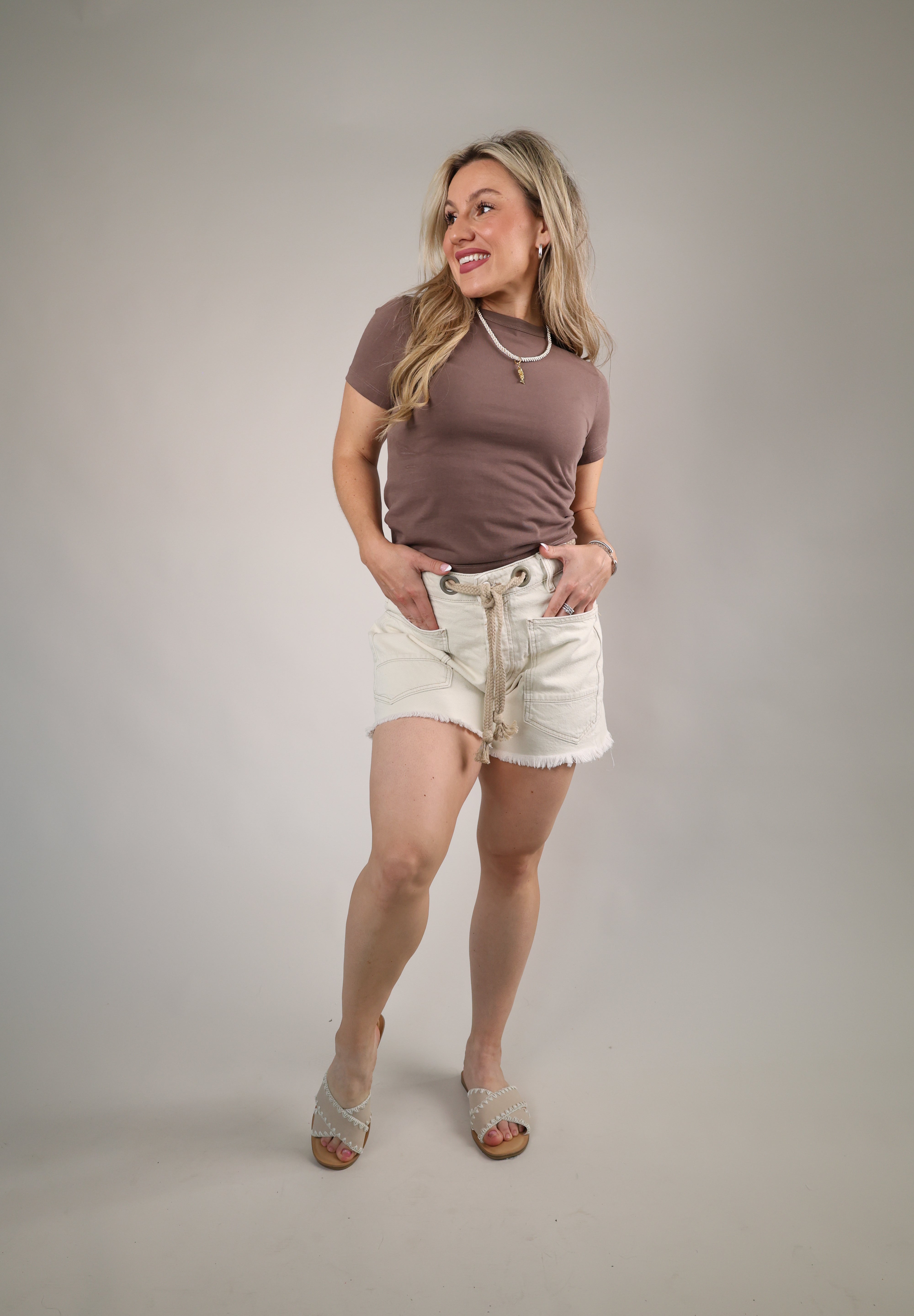 Relaxed fit white denim shorts with oversized front pockets and lived-in raw edge hem