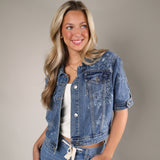 Shear Boutique Blu Denim Jacket featuring a modern trucker silhouette and extended short sleeves for effortless summer layering