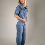 Stylish denim layering jacket from Shear Boutique designed with adjustable side ties and lightweight summer ready construction