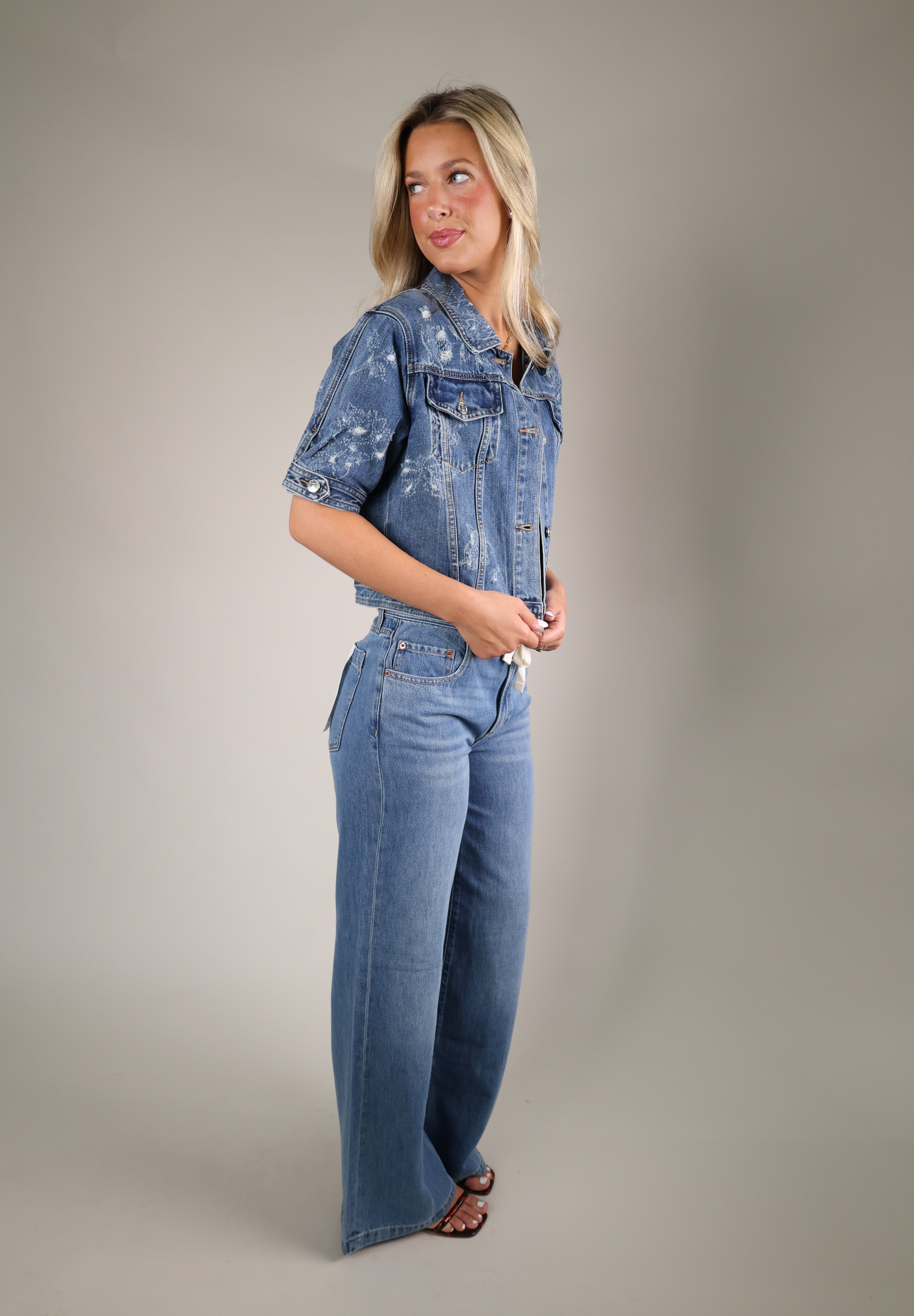 Stylish denim layering jacket from Shear Boutique designed with adjustable side ties and lightweight summer ready construction