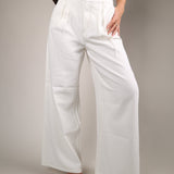 Lightweight off white wide leg pants from Shear Boutique featuring soft front pleats and a breezy drapey feel for summer outfit